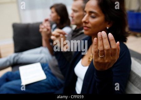 Family praying at home, Paris, France, Europe Stock Photo