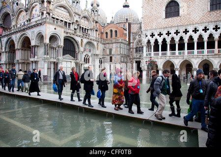 Tourists walking on footbridges during high tide in St. Mark's Square, Venice, UNESCO World Heritage Site, Veneto, Italy, Europe Stock Photo