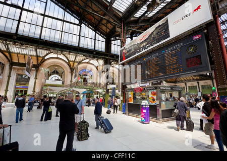 Passengers traversing through train station, by the arrival/departure board, Gare de Lyon train station, Paris, France, Europe Stock Photo