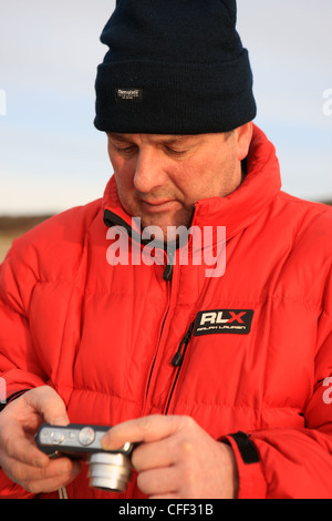 Man looking at a camera screen Stock Photo