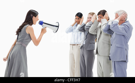 Woman yelling in a megaphone at business people Stock Photo