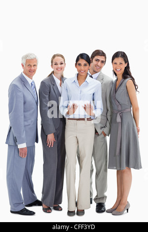 Smiling business team using a touchpad Stock Photo