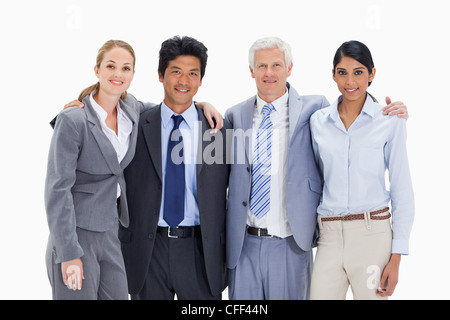 Smiling business team arm in arm Stock Photo