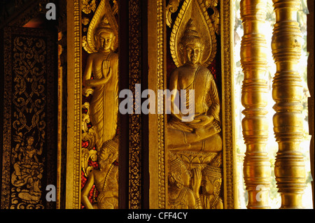 Reliefs with Buddhas at the windows, Wat Ho Pha Bang at the Royal Palace, Luang Prabang, Laos Stock Photo