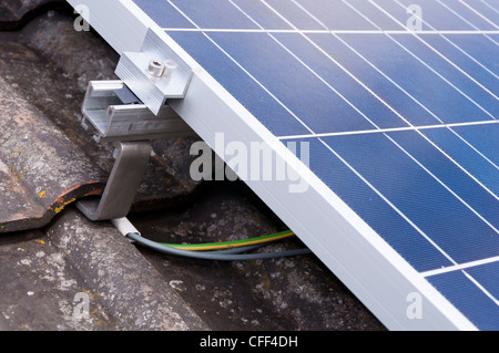 Solar panels fitted to the tiled roof of a UK home. Stock Photo
