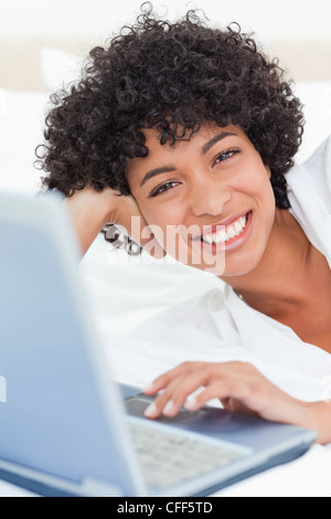 Portrait of happy woman lying on couch drawing in sketchbook Stock ...