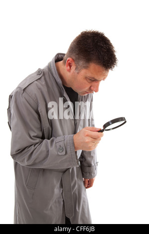 Man with raincoat is looking with magnifying glass over white background Stock Photo