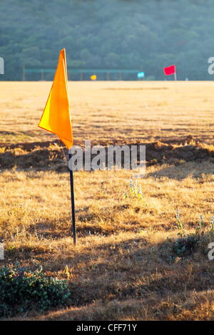 landscape of 100m markers at a golf drive range in Mahabhaleshwar India, Long evening shadows and colors of flags Stock Photo
