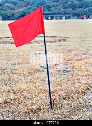 portrait of red flag on golf drive range in India, colored flags marking 100 metres Stock Photo