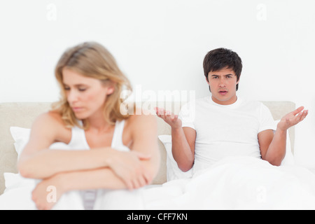 Man looks confused as the woman turns her head away while facing away from him Stock Photo