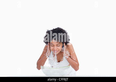 Relaxed young woman splashing her face with water Stock Photo