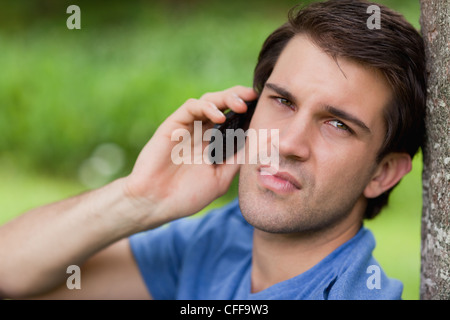 Young man using his cellphone in the countryside Stock Photo