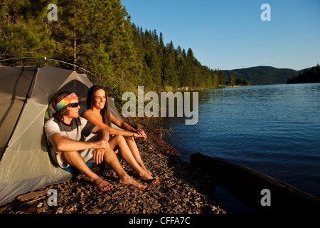 Two young adults laugh and smile on a camping and kayaking trip in Idaho. Stock Photo