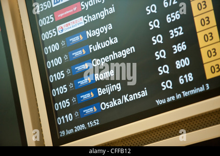 Flight departure and arrival information on electronic monitors at Changi Airport in Singapore Stock Photo