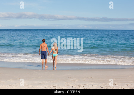 Back view of a couple spending time on the beach Stock Photo