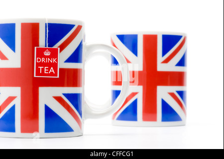 Two Union Jack mugs with teabag string, shot in studio on a white background. Stock Photo