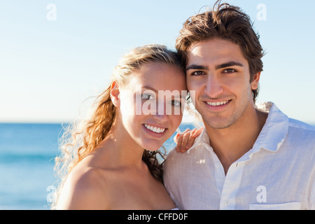 Couple standing on the beach Stock Photo