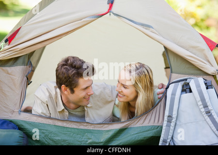 A smiling couple lying in their tent Stock Photo
