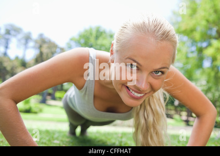 Sportswoman doing push ups Stock Photo