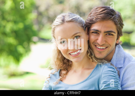 Smiling couple hugging in the park Stock Photo