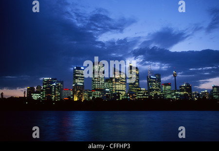 CBD (Central Business District) skyline at night with storm clouds from across Farm Cove Sydney New South Wales Australia Stock Photo