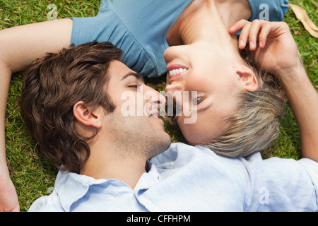 Happy couple lying on the lawn Stock Photo