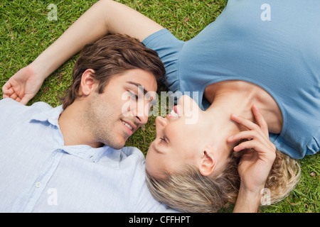 Couple relaxing on the lawn Stock Photo
