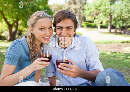 Couple drinking wine in the park Stock Photo