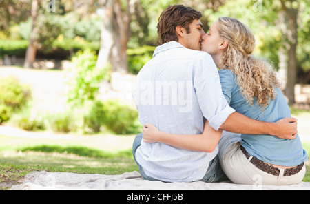 Rear view of a young woman kissing a mid adult man Stock Photo - Alamy