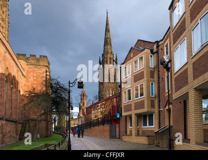 The spire of the old cathedral in the late afternoon with Holy Trinity Church to the left, Coventry, West Midlands, England, UK Stock Photo