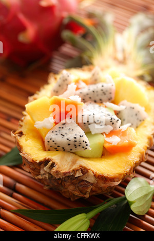 Tropical salad with dragon fruit and papaya inside pineapple Stock Photo