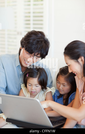 Happy family with kids with laptop Stock Photo - Alamy