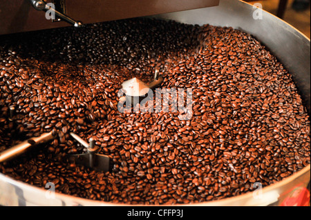 Coffee being roasted in a small roasting machine. Stock Photo