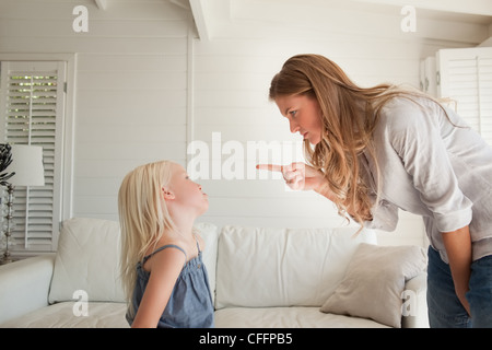 Young mother scolding her daughter for bad behavior and mistakes Stock