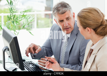 Businessman giving instructions to his secretary Stock Photo