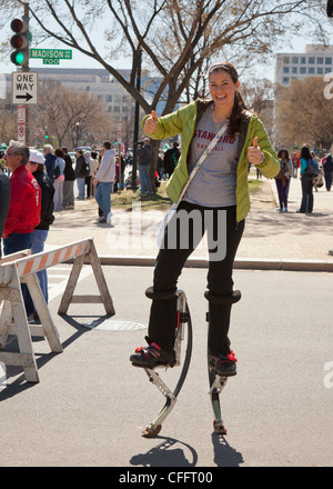 A woman walking on jumping stilts - USA Stock Photo