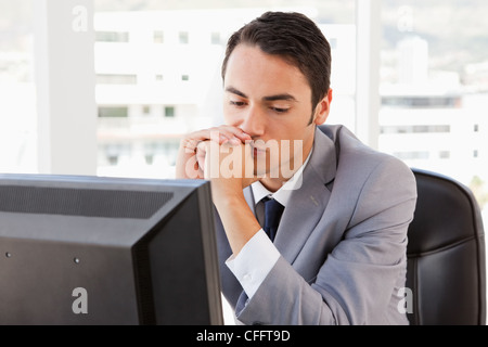 Bored businessman in front of his computer Stock Photo