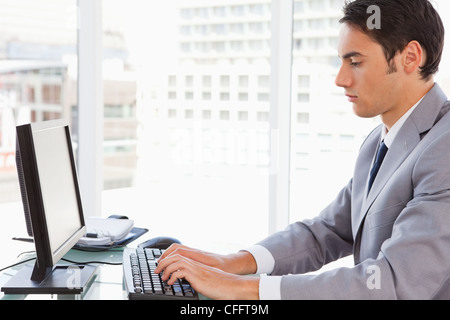 Businessman typing on his keyboard Stock Photo