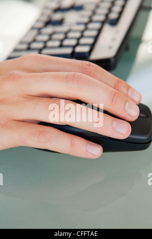 Close-up of man's hand moving a mouse Stock Photo