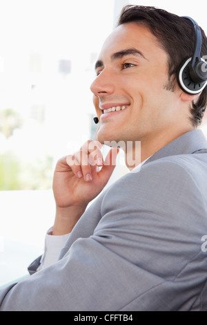 Happy businessman talking with a headset Stock Photo