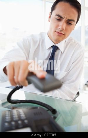 Businessman hanging up while frowning Stock Photo