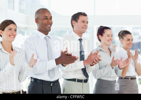 Applauding salesteam standing in a line Stock Photo