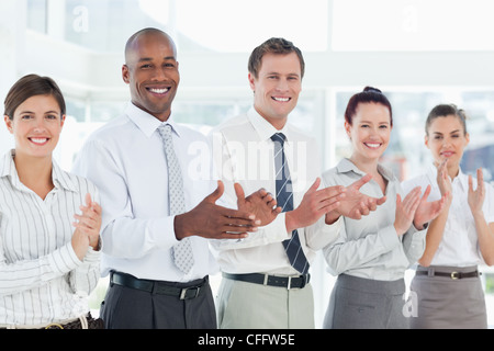 Clapping salesteam standing in a line Stock Photo