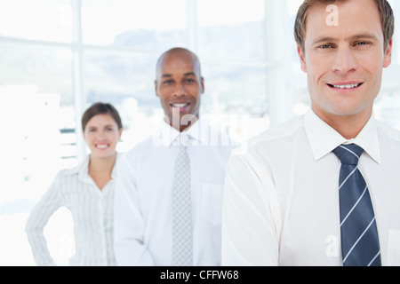 Smiling salesteam standing in a line Stock Photo