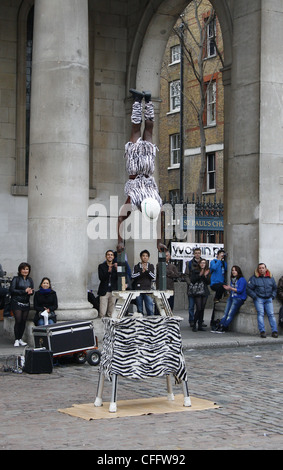 People watching street performers. Covent Garden, West End, City of Westminster, London, Greater London, England Stock Photo