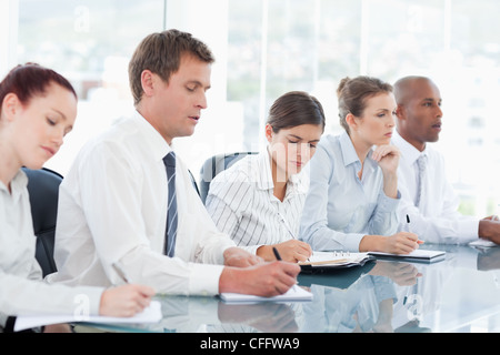 Salespeople taking notes during a meeting Stock Photo