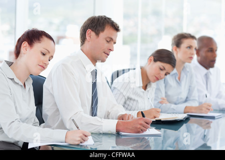 Business team taking down notes in the office Stock Photo