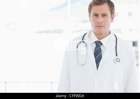 Doctor standing in front of a window Stock Photo
