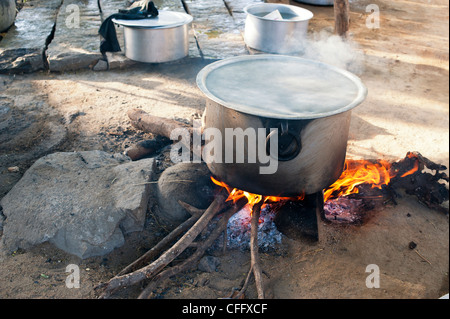 Cooking Rice in a large pot on an open fire in the Indian countryside. Andhra Pradesh, India Stock Photo
