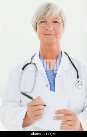 Doctor pointing at prescription pad Stock Photo